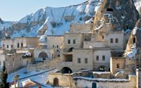 Stone houses built around Goreme's famous fairy chimneys, in winter